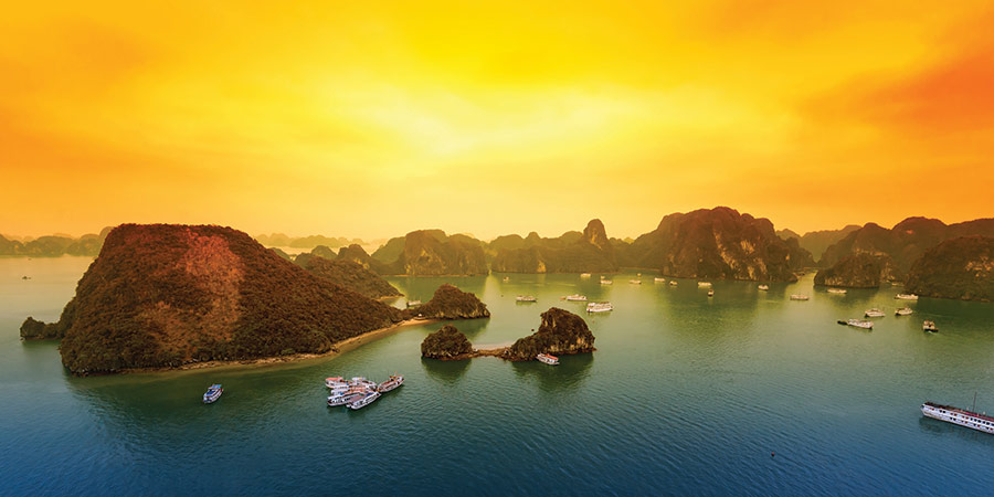 A sunset view of Halong Bay’s limestone islands